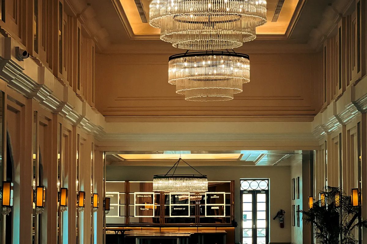 A grand city hotel lobby lit by crystal chandeliers